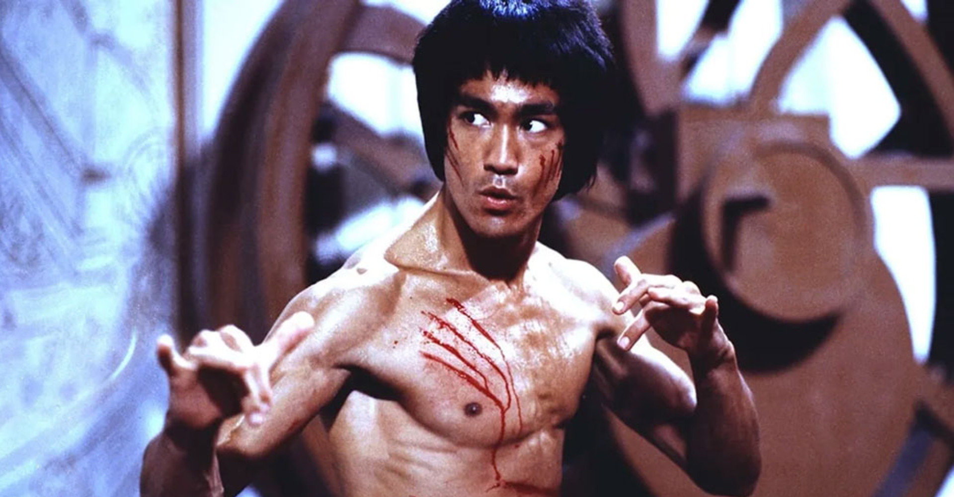 Bruce Lee with top off looking ready to fight kung fu