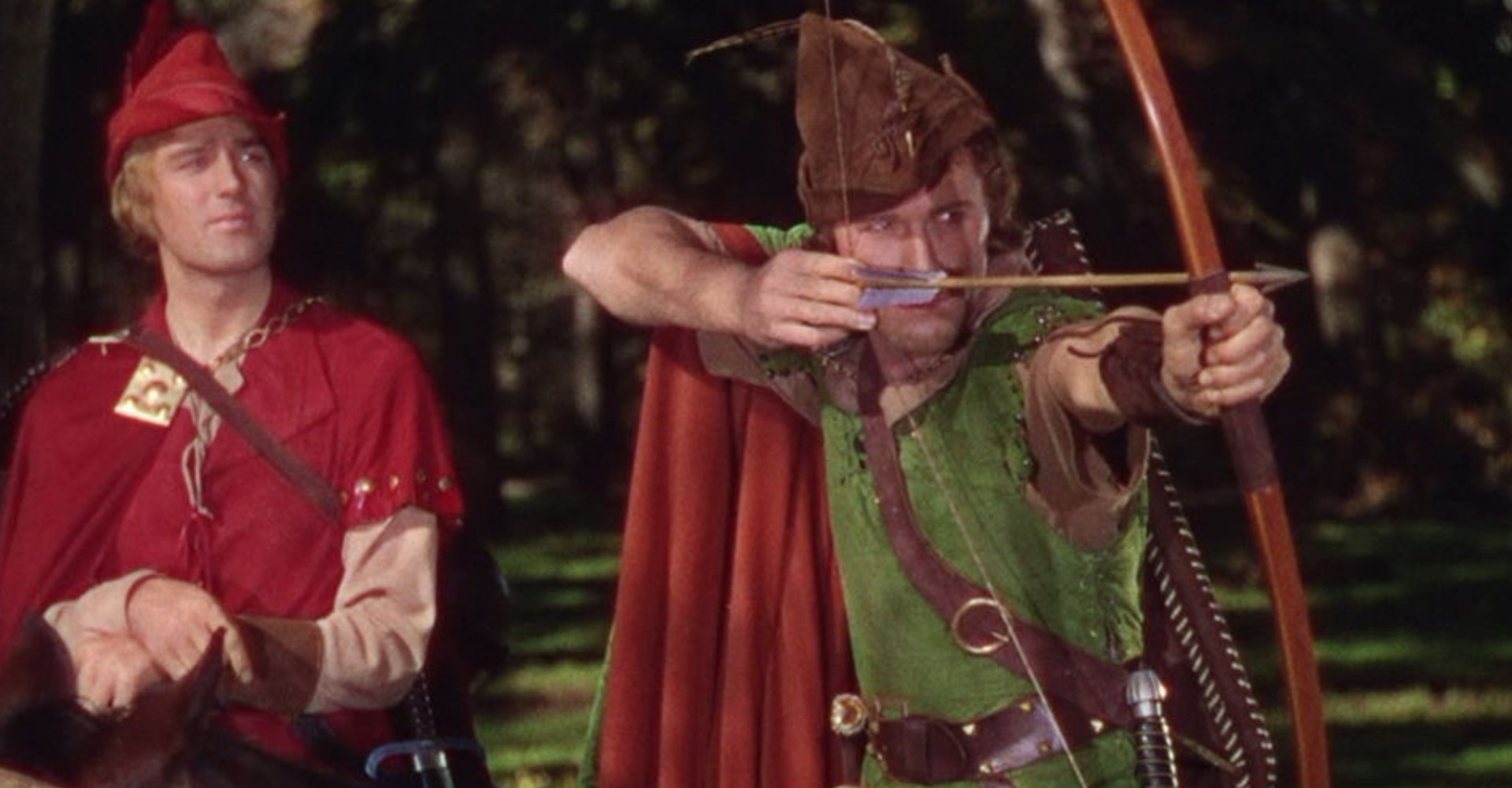 Robin Hood holding a bow and arrow and aiming