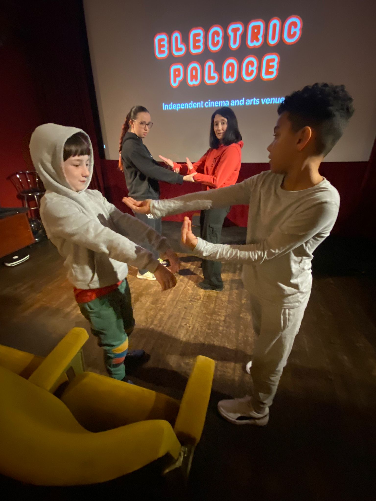 Group of children doing kung fu moves in cinema